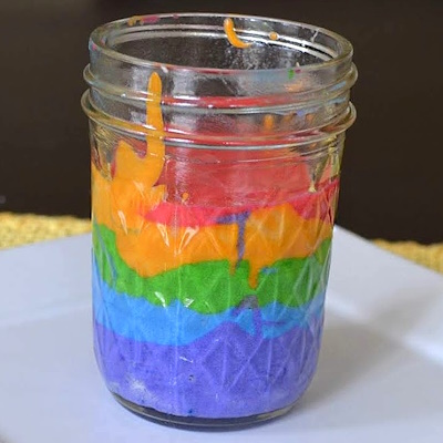 Layering your colored batter to make rainbow cake in a jar.