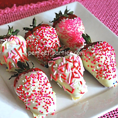 White chocolate covered strawberries with sprinkles.